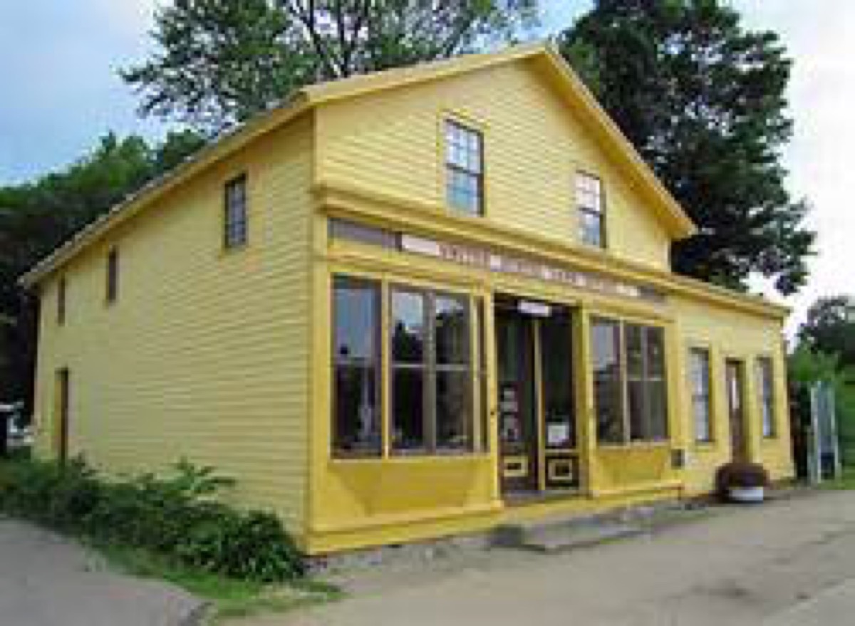 Land Office White Pigeon Land Office building with yellow siding and storefront windows.